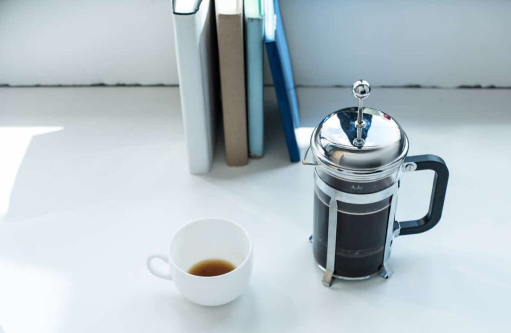 french press with white coffee mug