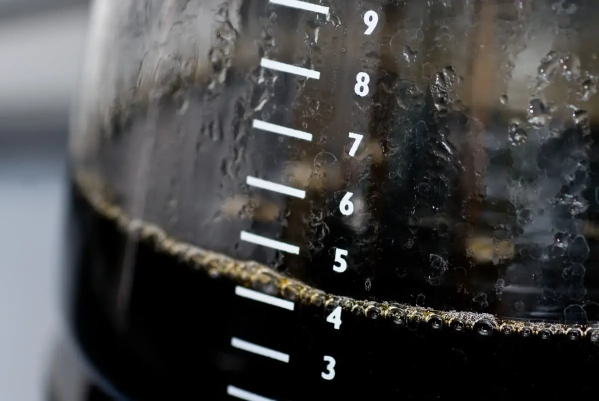 Coffee pot with only four cups left in pot. Condensation in pot.