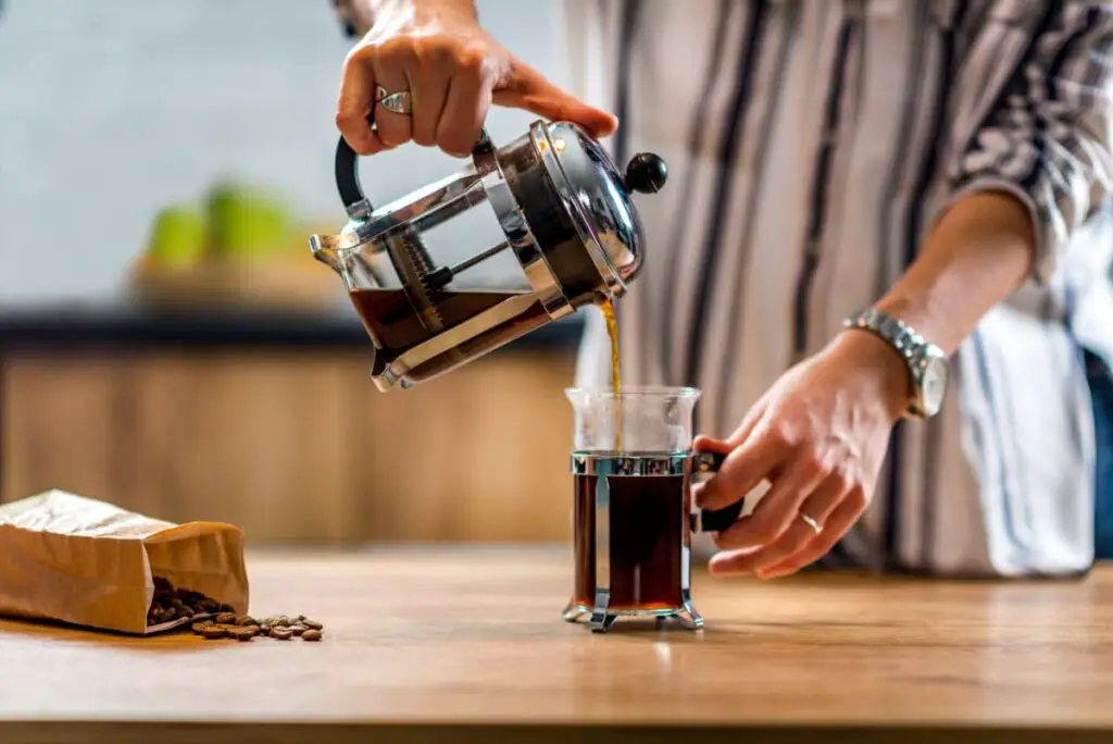 woman preparing coffee using french press