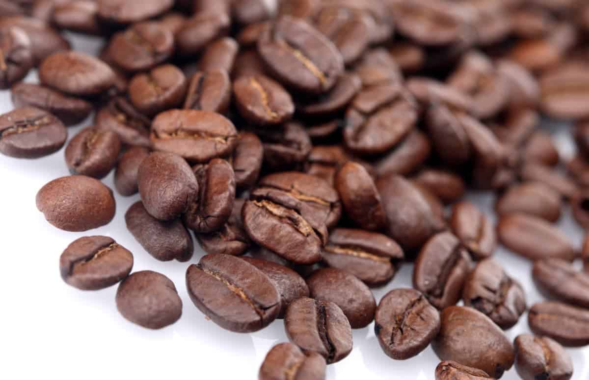 Coffee beans laying on white background.