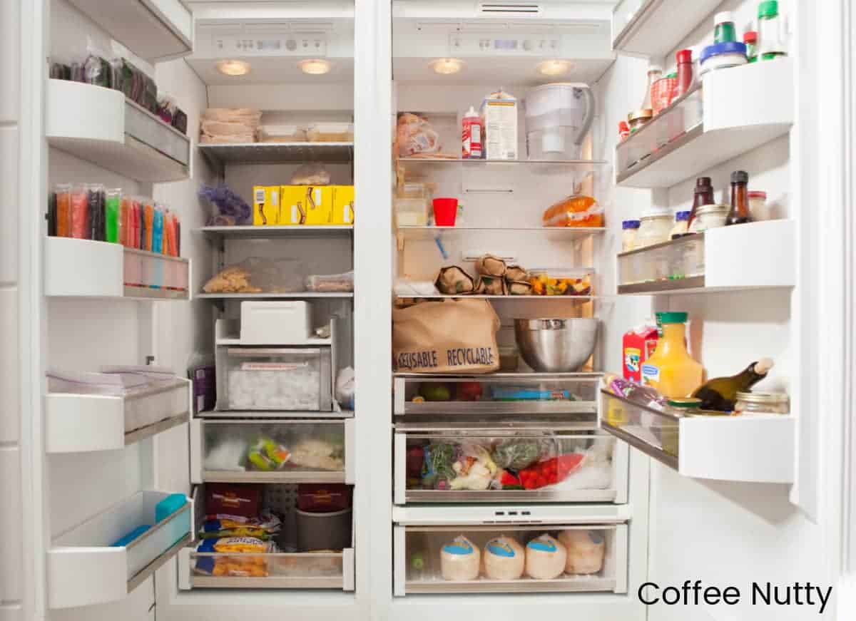 Open fridge stocked with food and drinks.