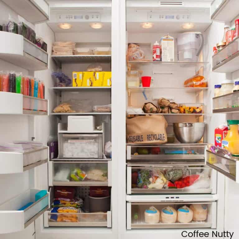 Open refrigerator full of various foods and beverages.