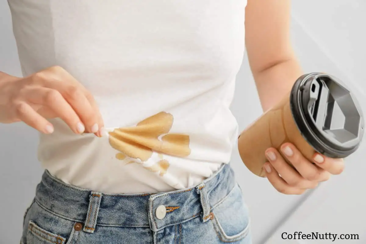 Woman with fresh coffee stain on white t-shirt.