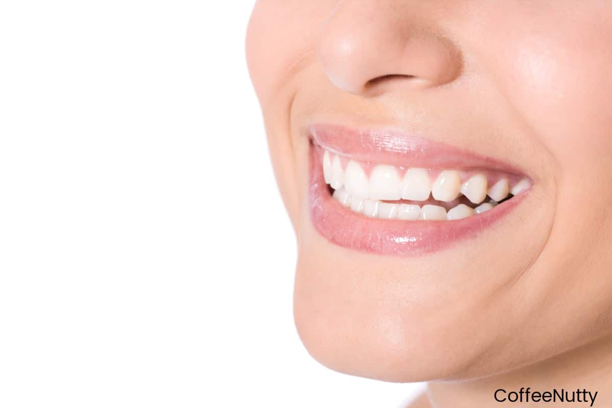 Close up image of woman smiling, showing nose and mouth.