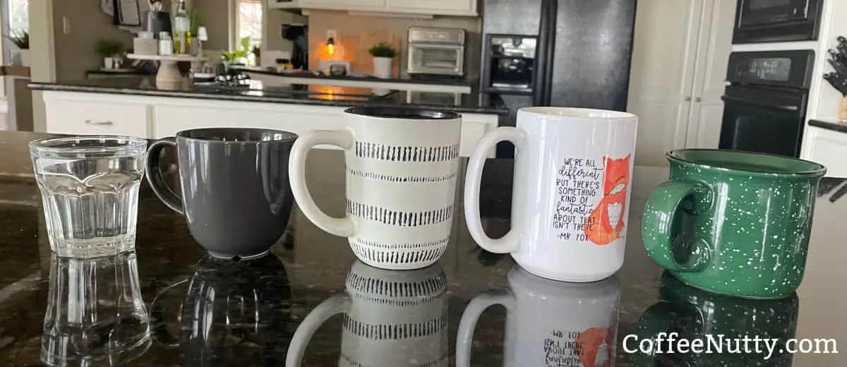 5 different size cups and mugs full of water.