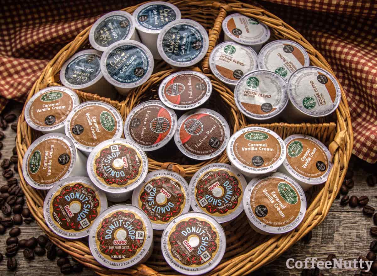 Various k cups for coffee and in wood basket.