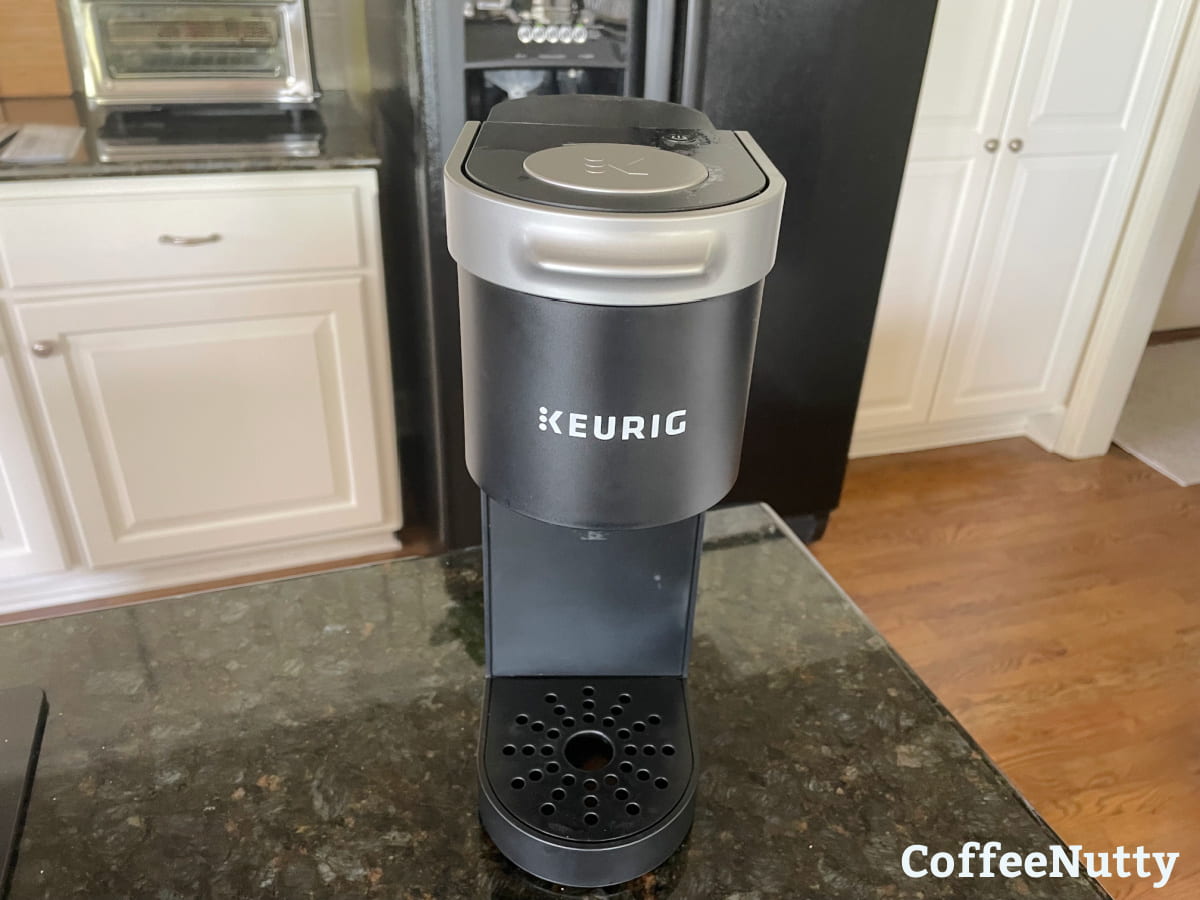 Keurig coffee maker on granite countertop.