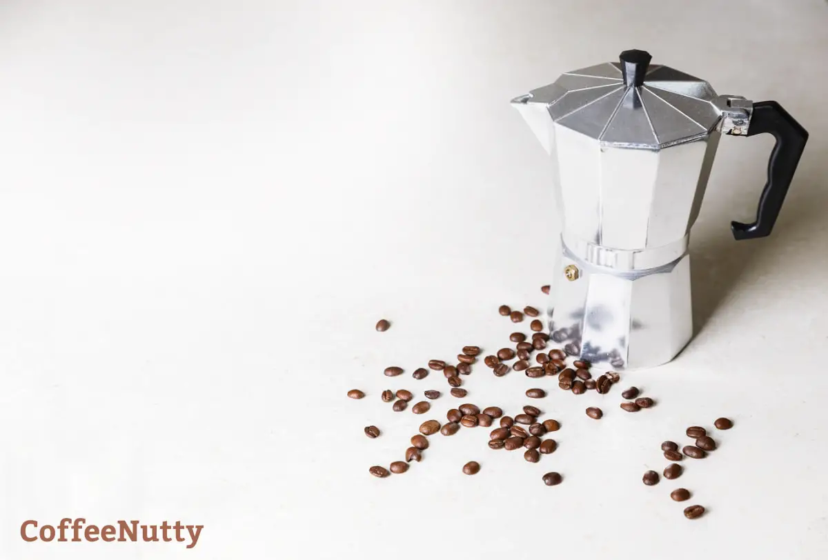 Moka Pot on white background by coffee beans.