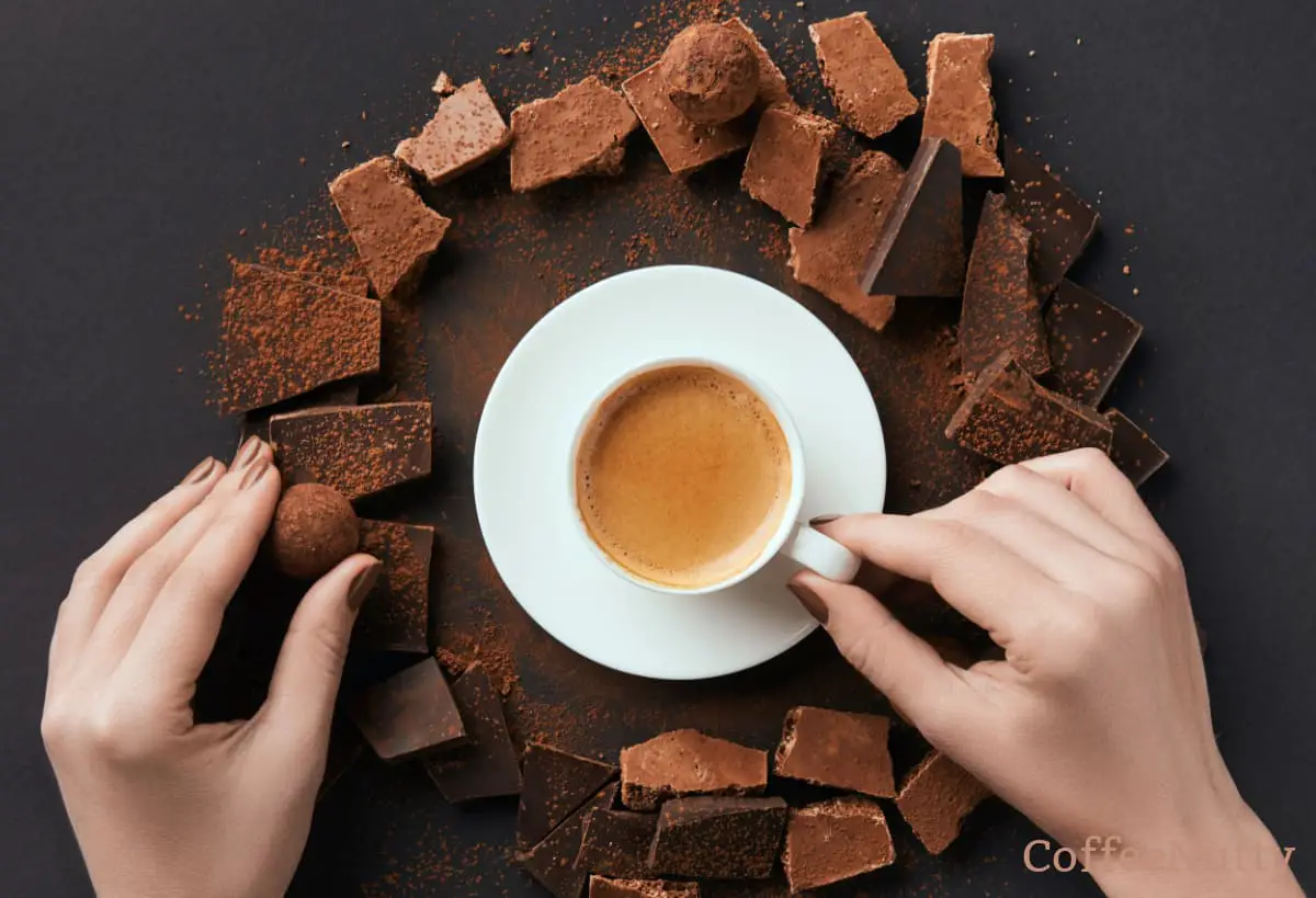 Unsweetened cocoa surrounding a cup of coffee sitting on a white saucer.