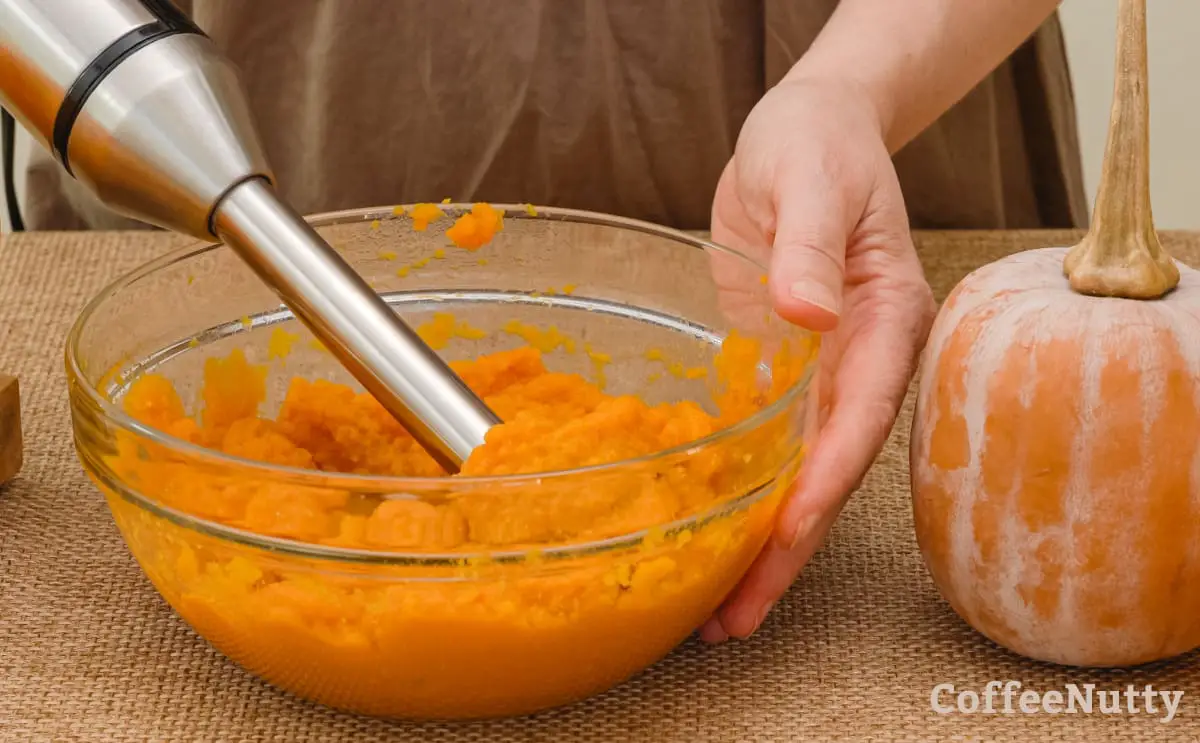 Mixing pumpkin puree with hand mixer.