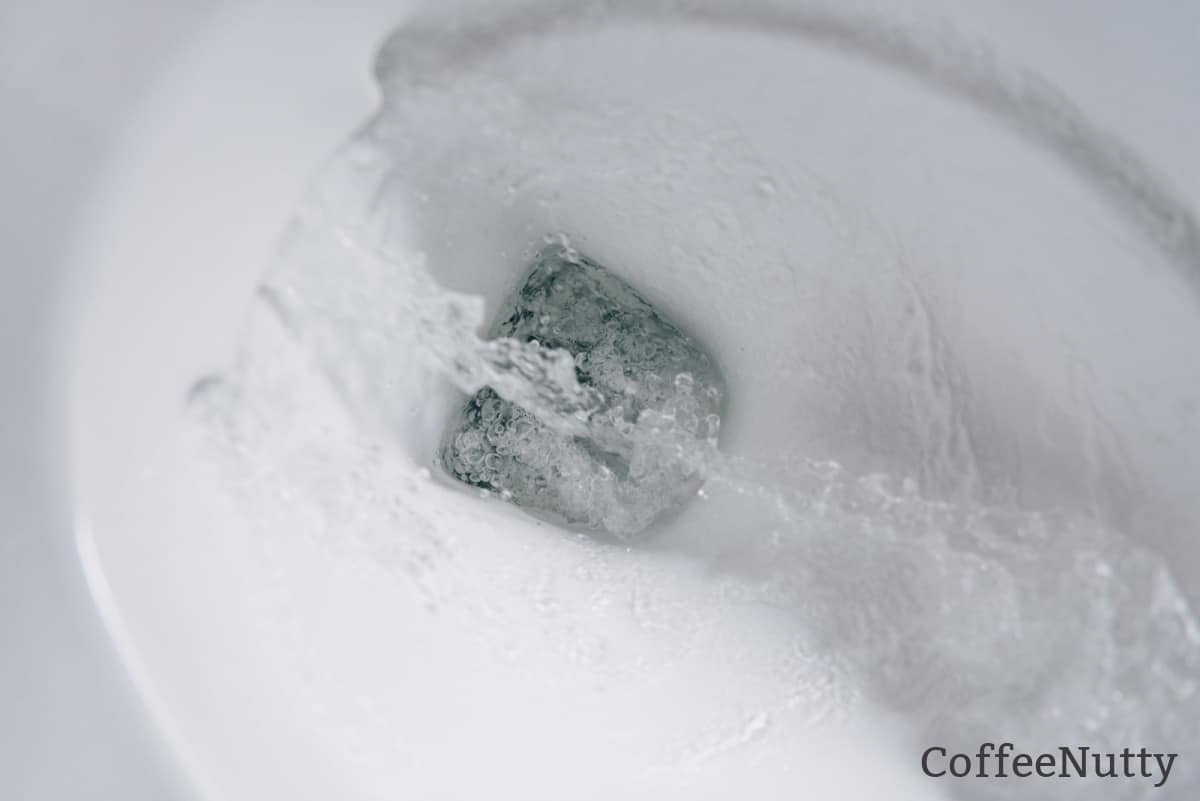 Toilet water flowing through flushing stool.