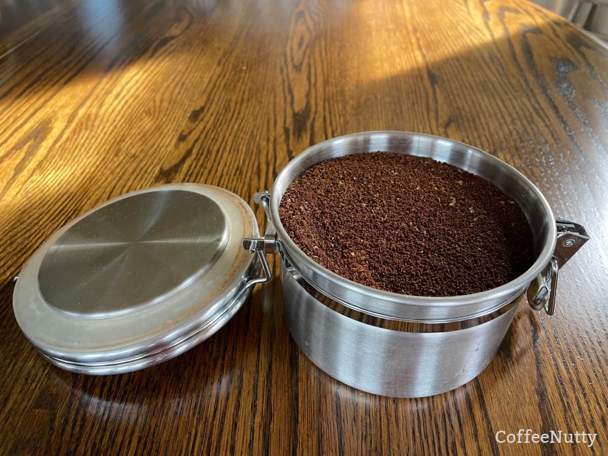 Stainless steel  container holding freshly ground coffee.