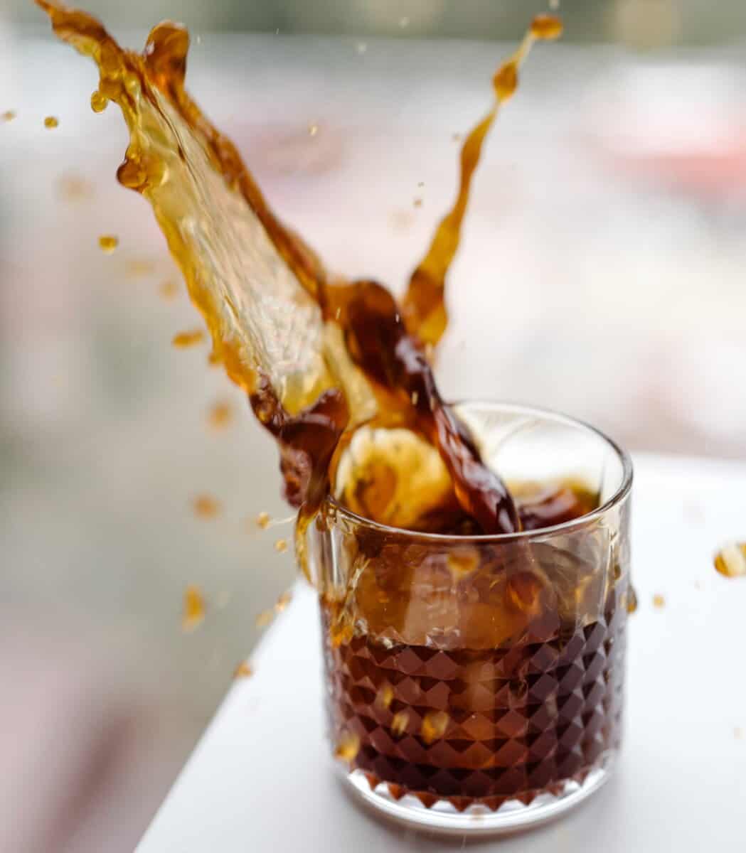 Ice splashing in cup of coffee.