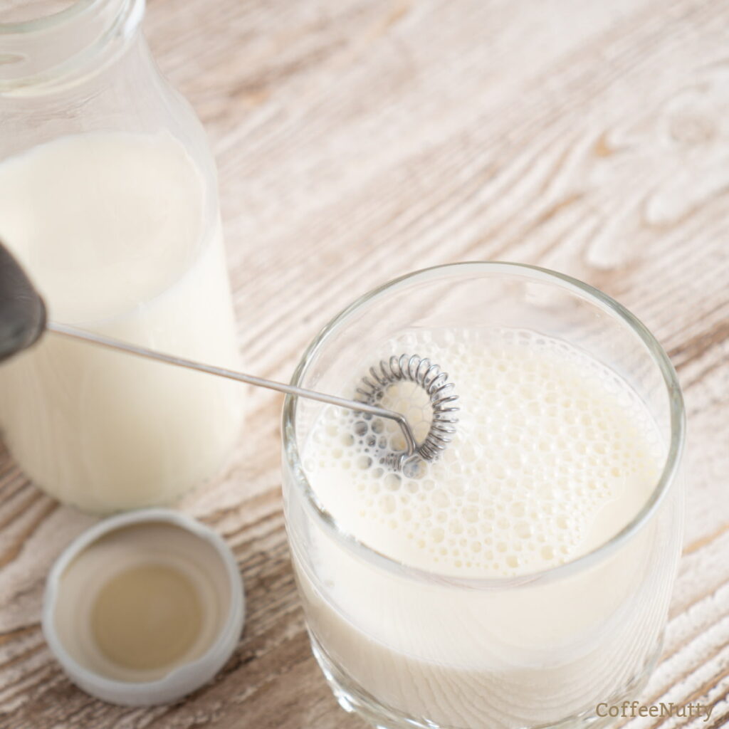 Frothing milk with milk frother.