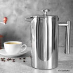 Clean stainless steel coffee percolator sitting on counter.