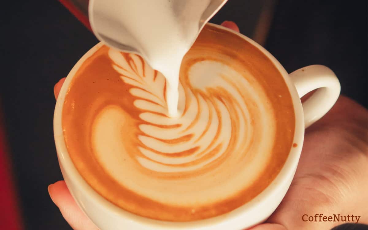 Creating coffee art with milk froth.