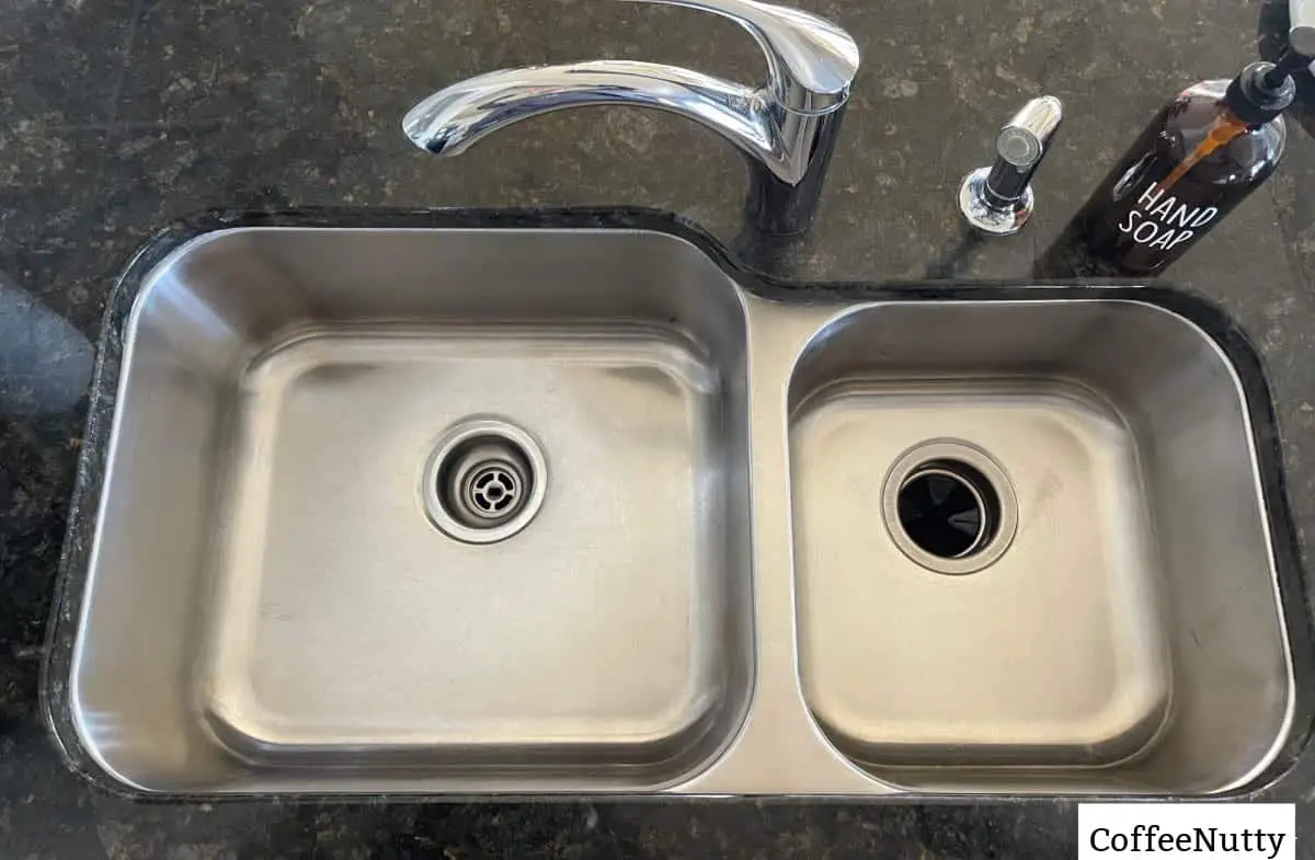 Kitchen sink stainless steel with view of garbage disposal.