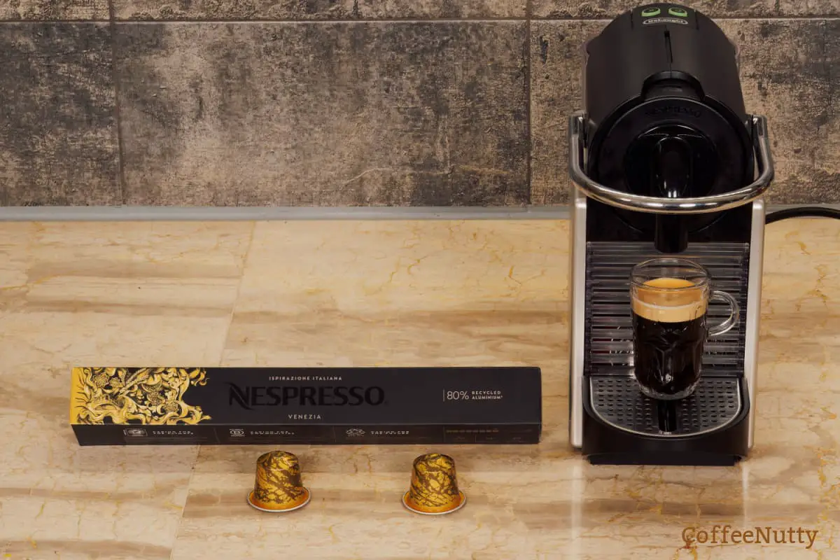 Nespresso coffee machine with coffee beverage with froth.